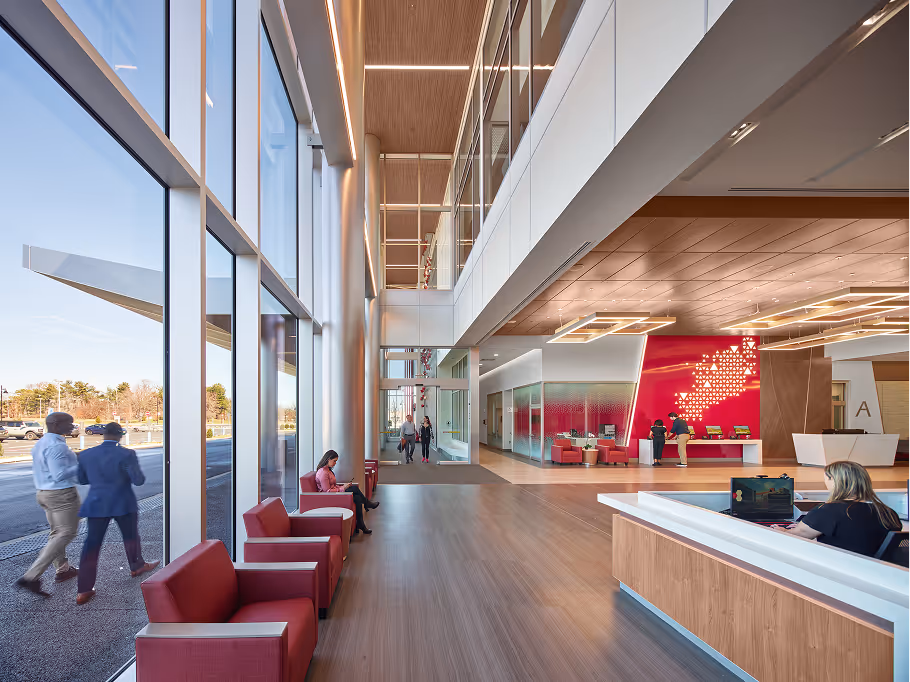 Modern hospital lobby with reception desk and seating area.

