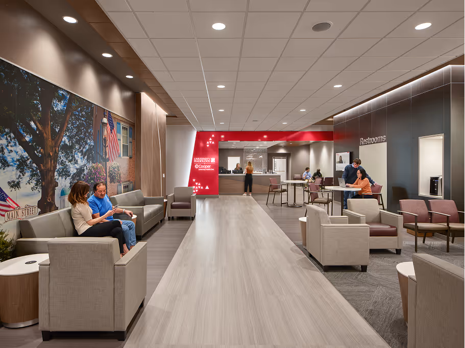 Modern healthcare waiting area with seating and reception desk.

