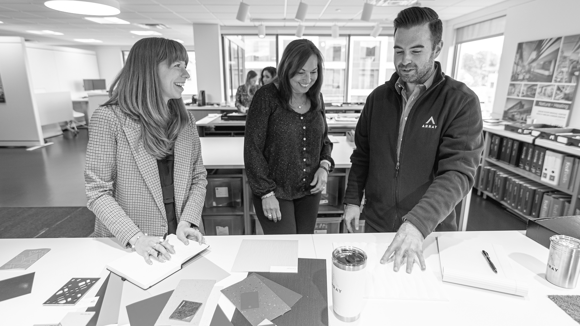 Team members reviewing design materials.
