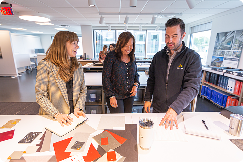 Team members reviewing design materials.
