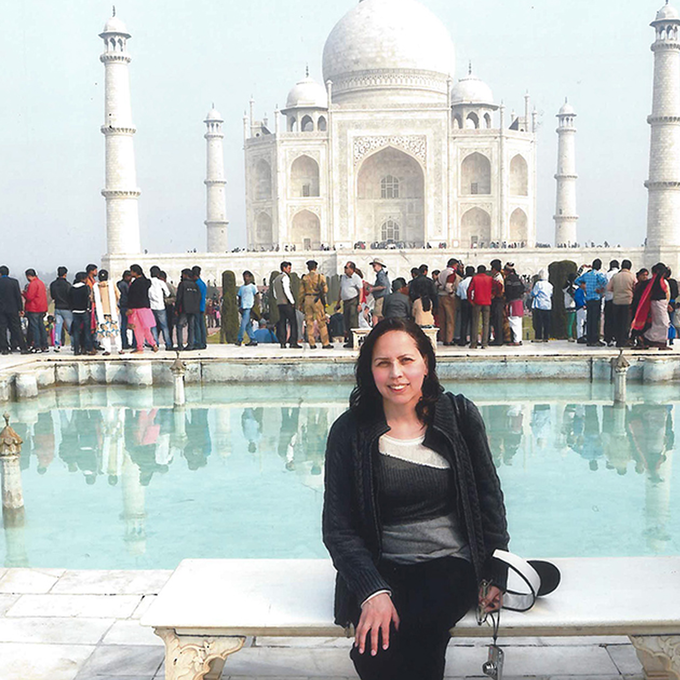 Woman sitting in front of the Taj Mahal.