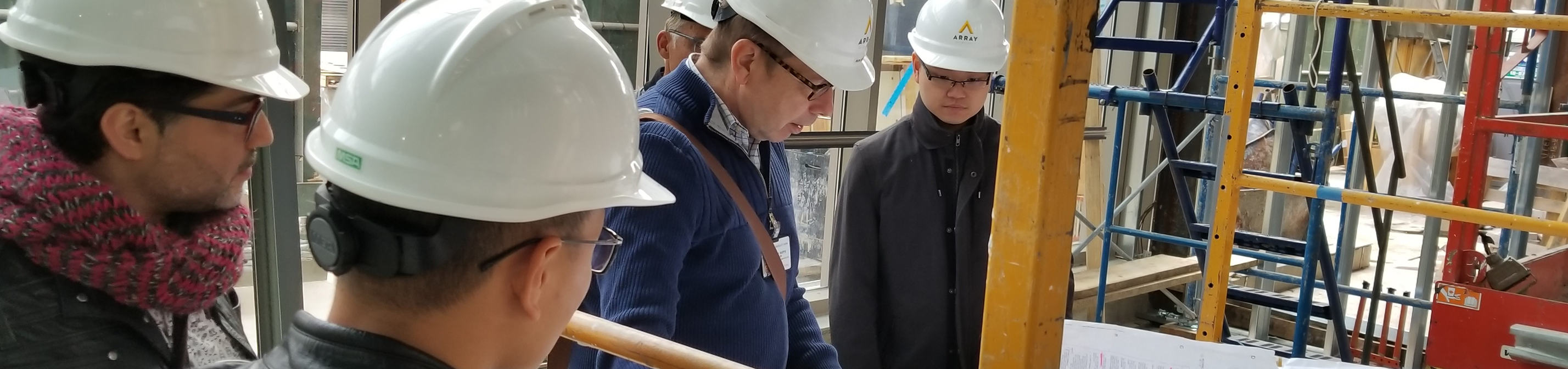 Team members reviewing plans at a construction site.