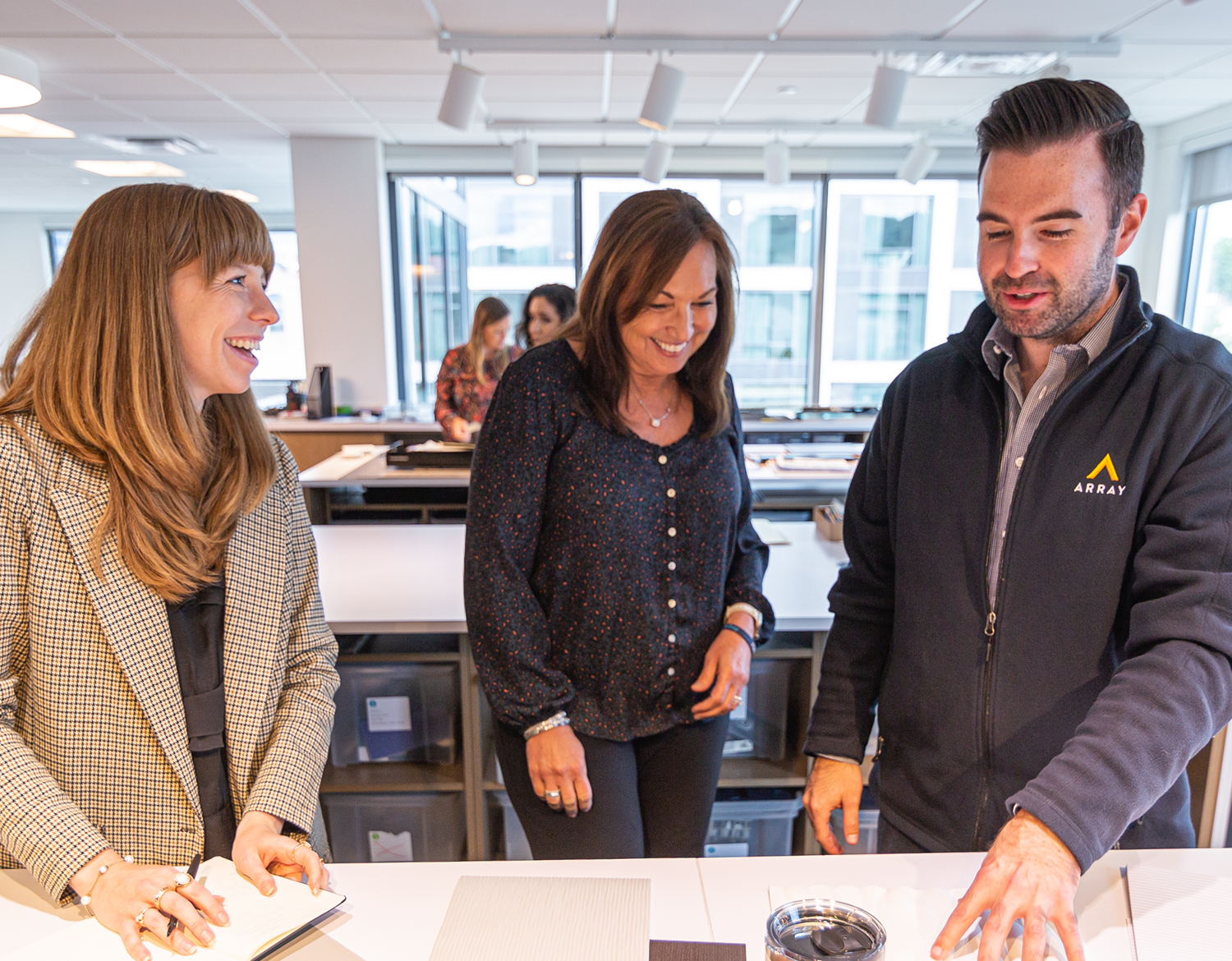 Team members reviewing design materials.
