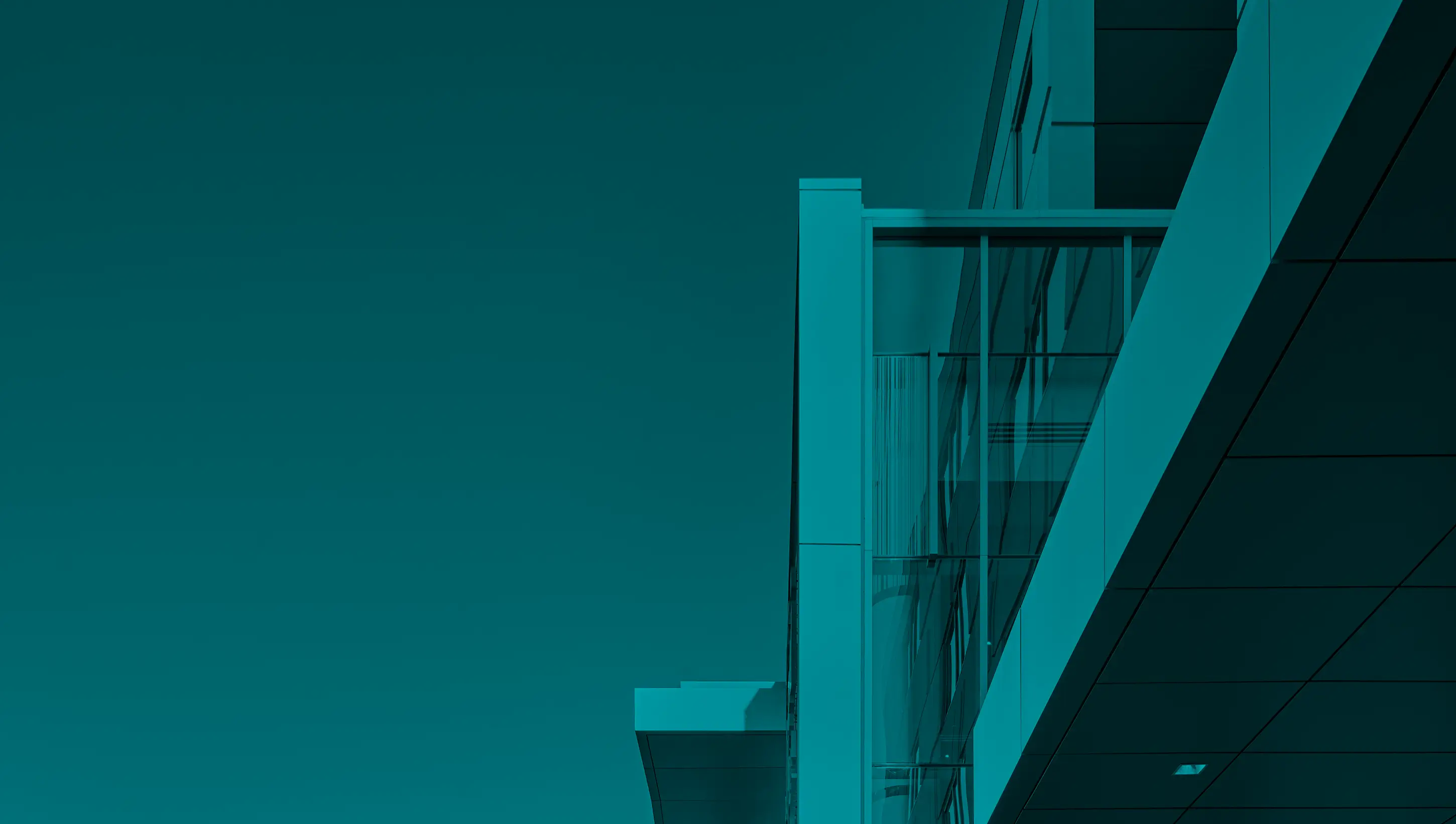 Modern office building exterior against a clear sky.
