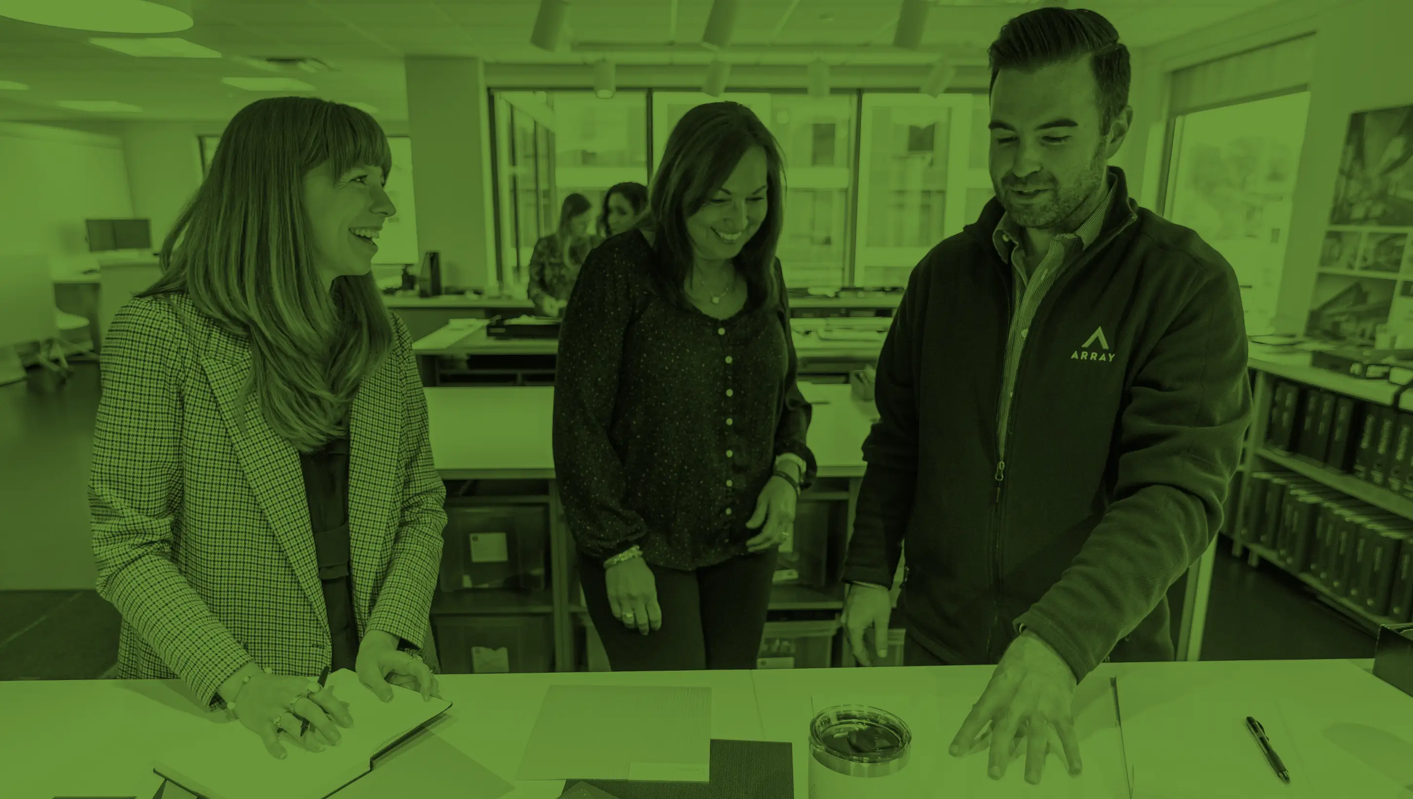 Team members discussing materials in an office.