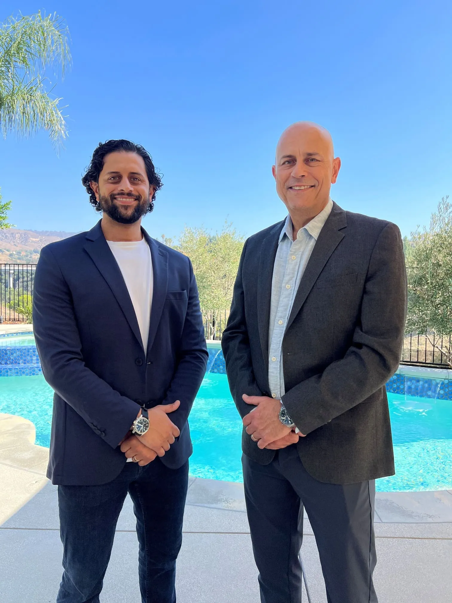 The founder of SoCal Pools standing by a swimming pool outdoors.