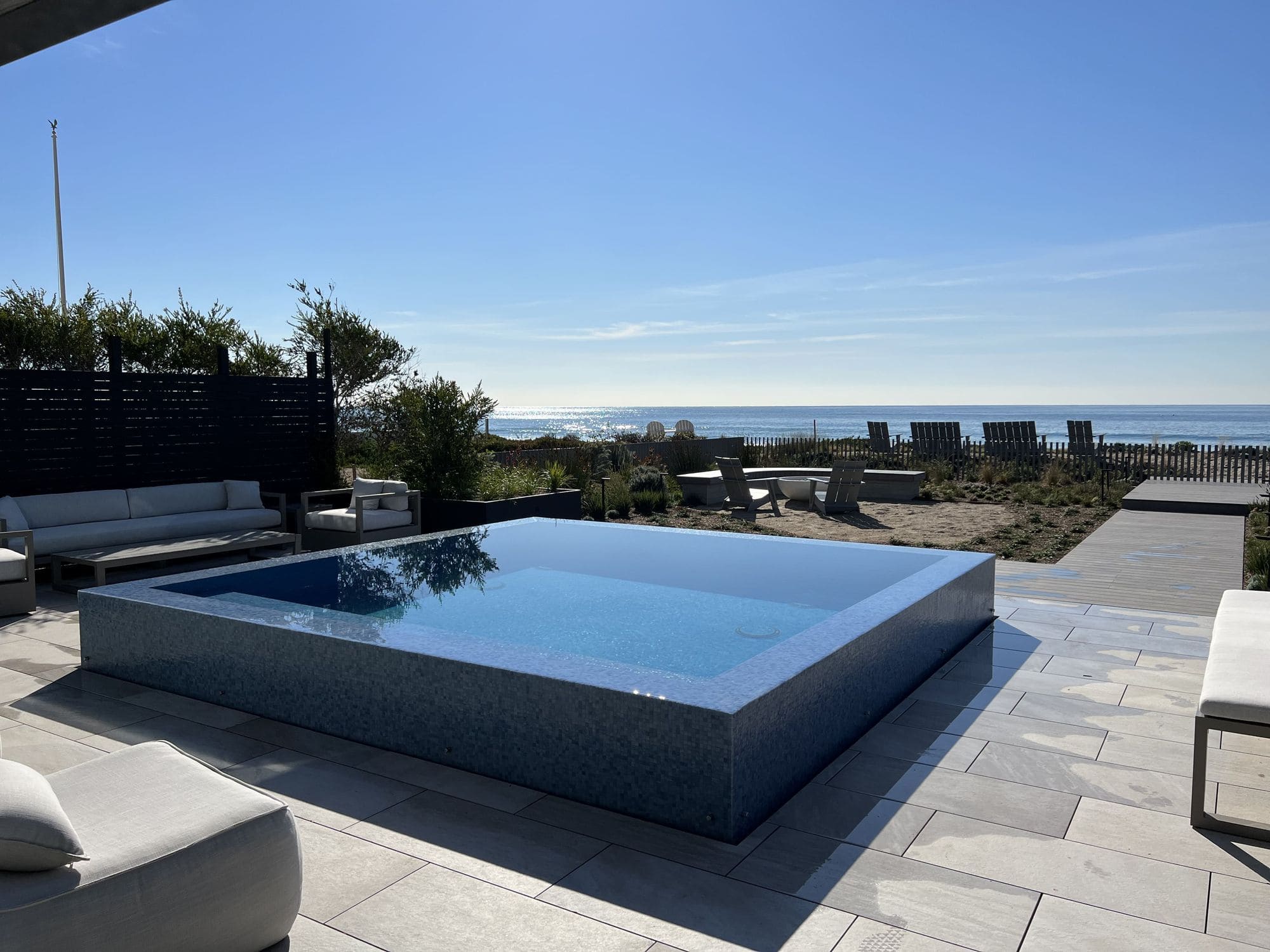 Newly constructed infinity edge pool with an oceanfront view and outdoor lounge area on Broadbeach Road in Malibu