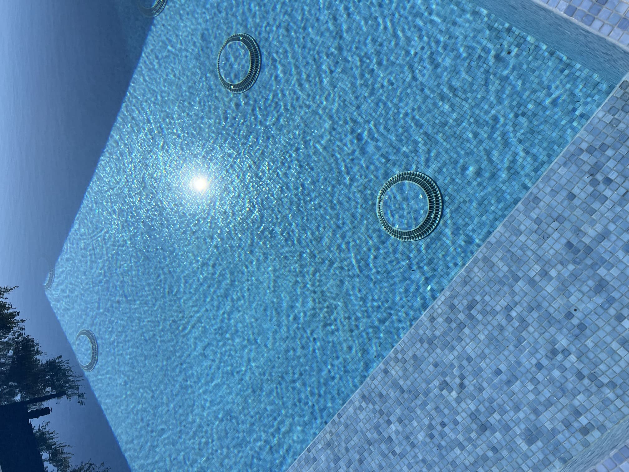 Close-up of clear blue swimming pool water reflecting sunlight in Canyon Country