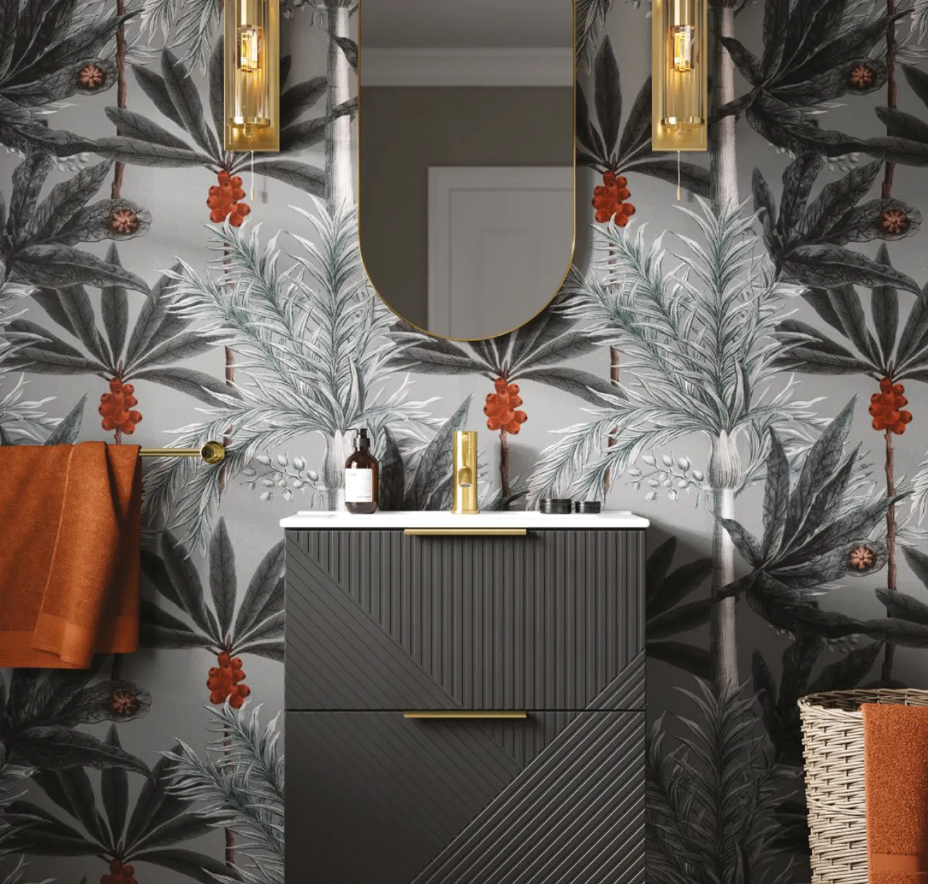 Modern bathroom vanity with a textured dark cabinet, white countertop, gold faucet, and an oval mirror, set against a gray botanical wallpaper with red berries.