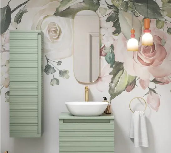 Bathroom with floral wall mural, vertical oval mirror, green vanity with white vessel sink, and hanging pendant lights.