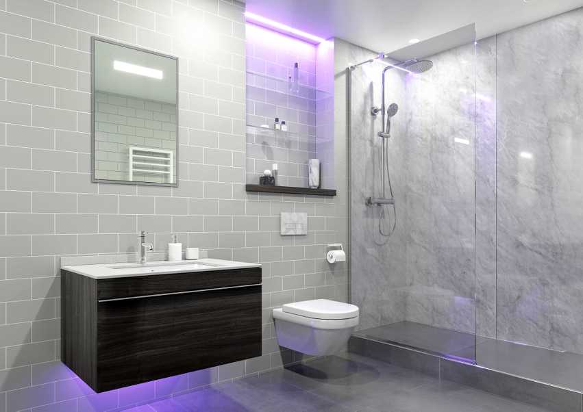 Modern bathroom with gray tiled walls, a floating dark wood vanity with white countertop, a wall-mounted toilet, and a glass-enclosed shower with marble walls and purple ambient lighting.