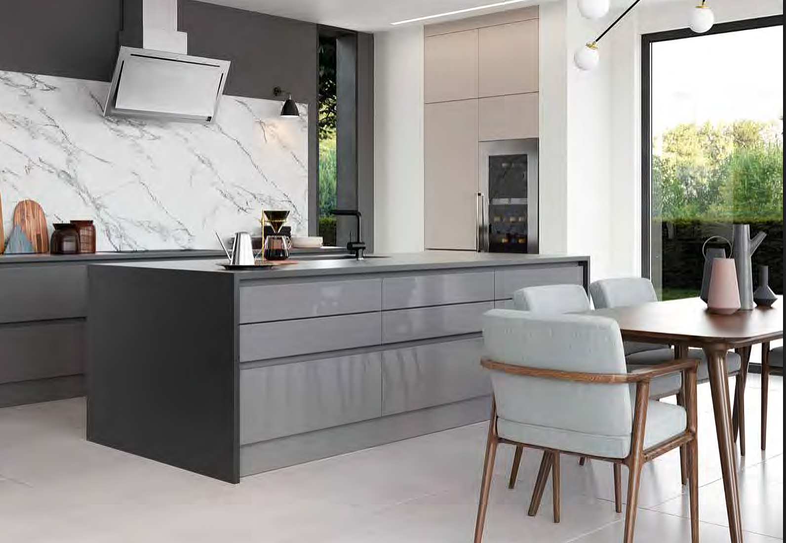 Modern kitchen with dark gray island, marble backsplash, light gray chairs, wooden dining table, and large window overlooking greenery.