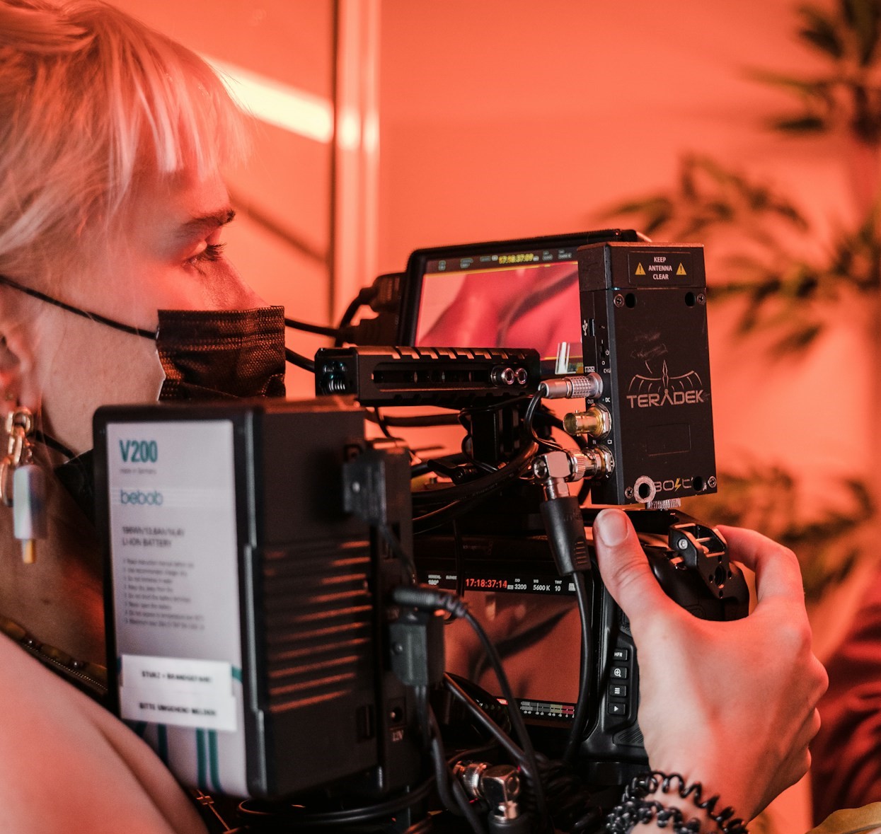 person operating a complex video camera