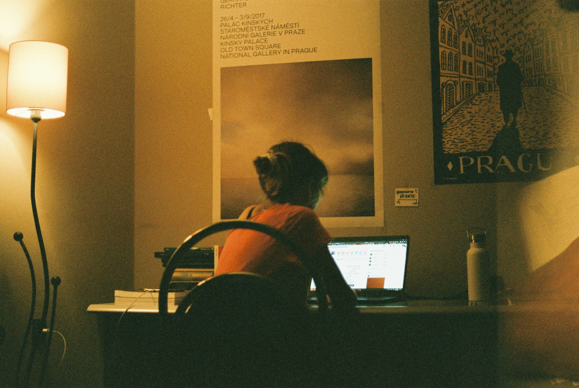 woman sitting in front of a computer on a desk