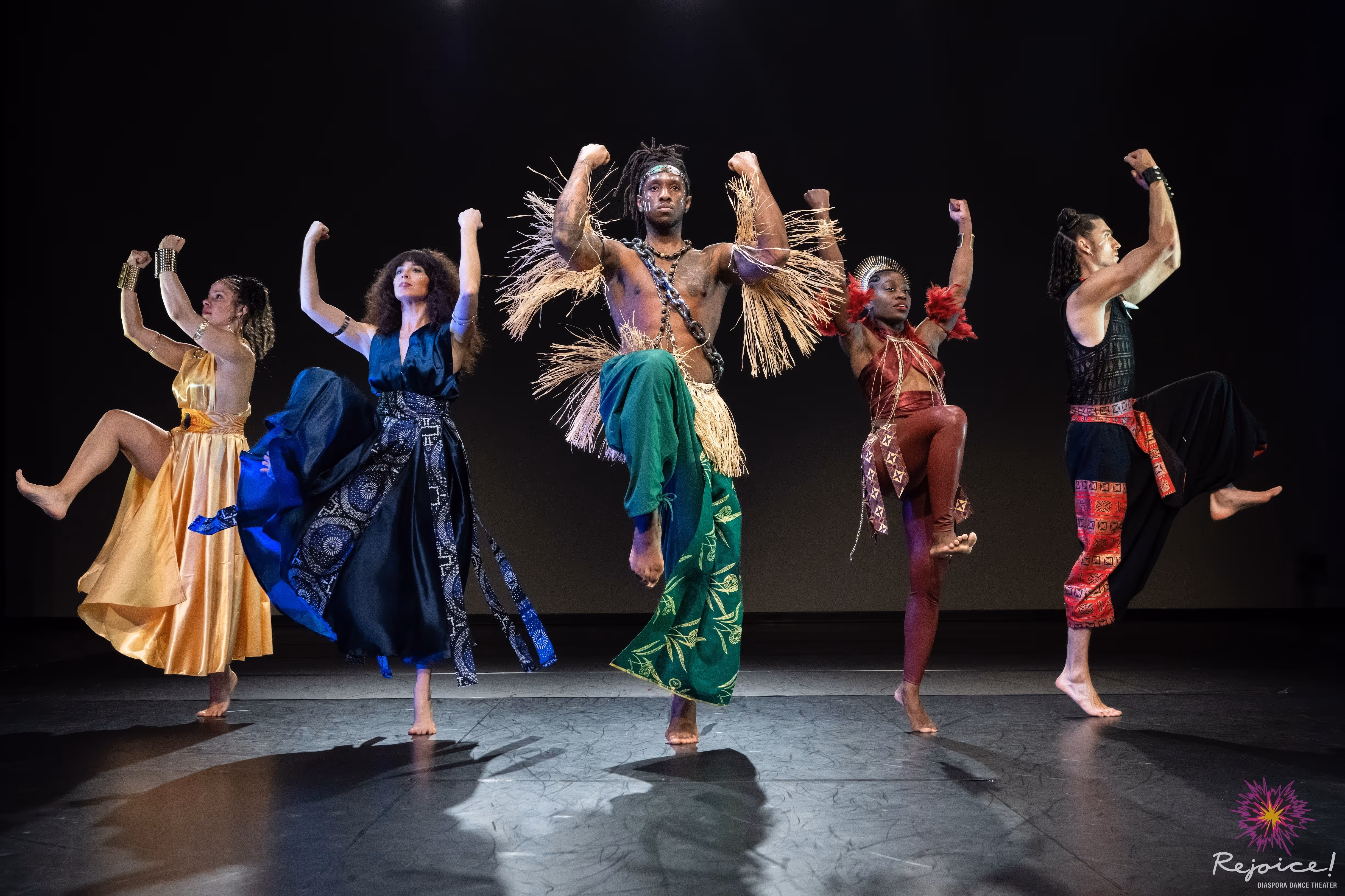 dancers pose standing in African clothing