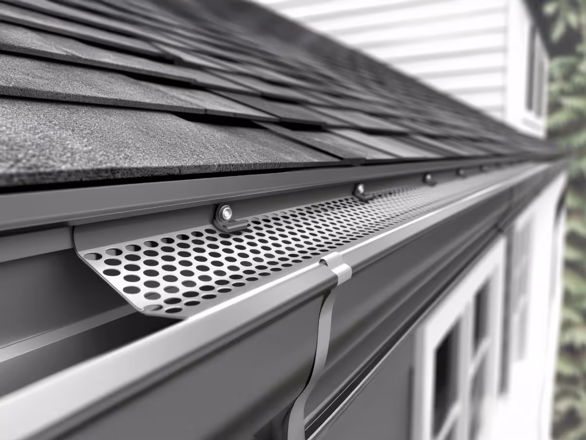 An aerial Drone photo of a client of Golden Eagle Roofing. A completed roof with an elegant sunset.