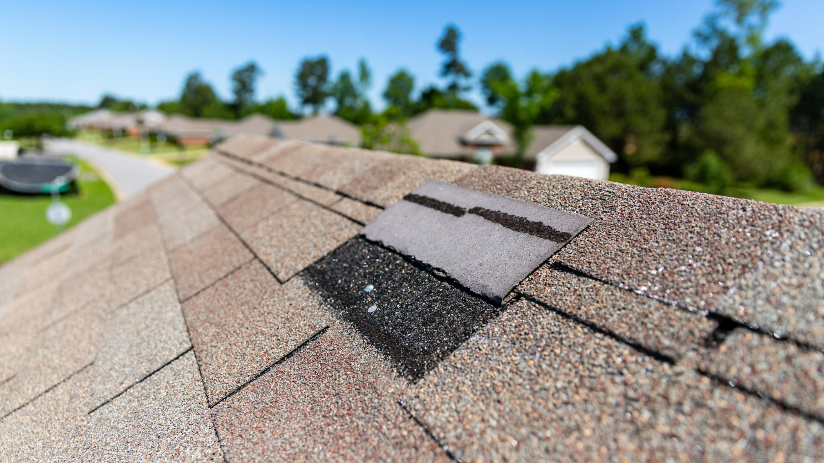 A roof installer using a nail-gun to repair the roof after a storm