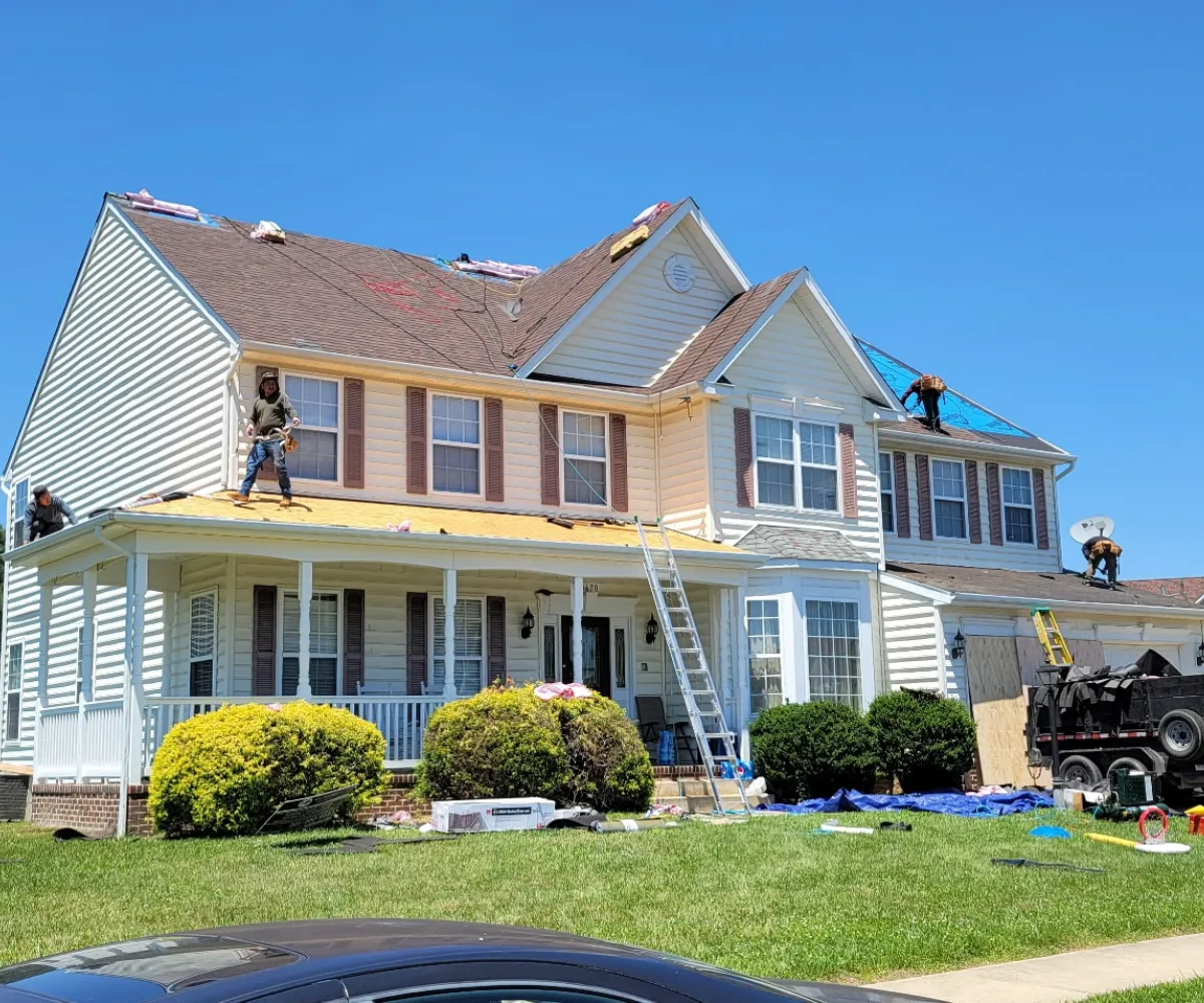 An aerial photo of a roof that was recently replaced by Golden Eagle Roofing. It showcases a black designer shingle on a Southern Maryland Home