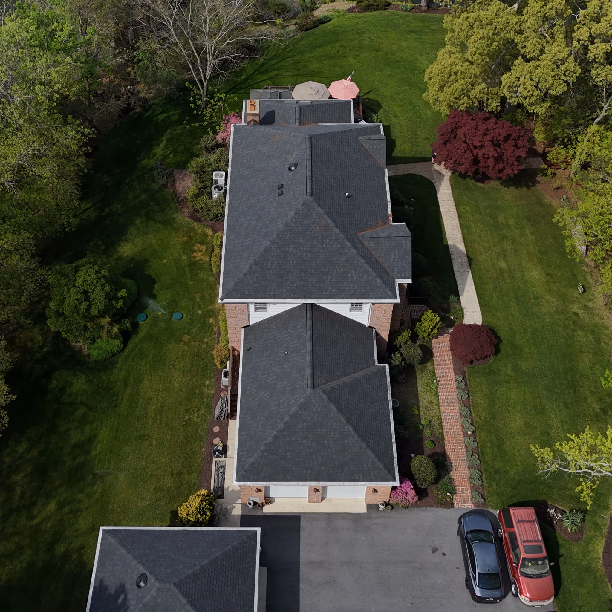A photo of a crane loading a townhome with Atlas Pinnacle Pristine roof shingles for a insurance-paid roof replacement in North Beach, Maryland by Golden Eagle Roofing, LLC