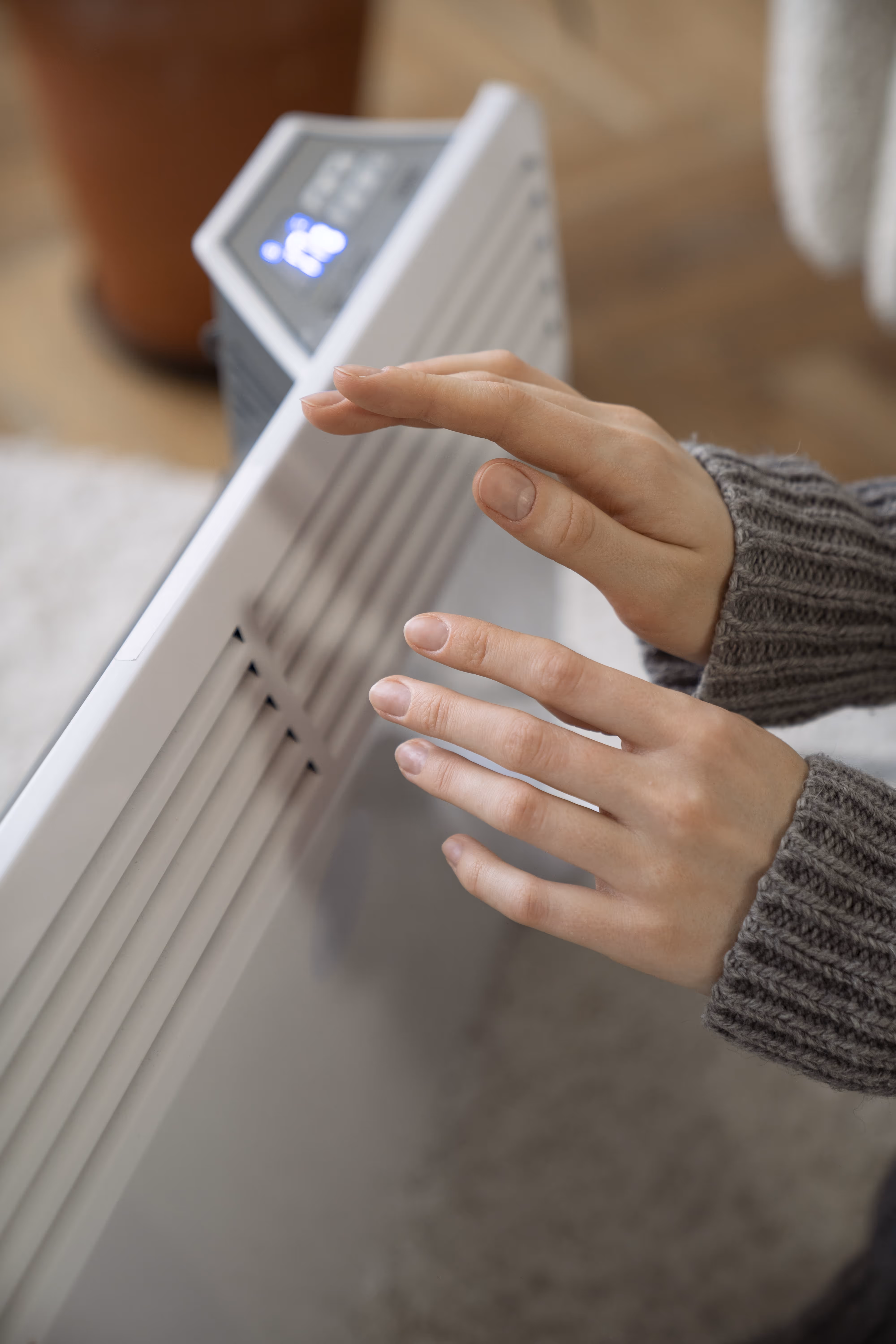close-up-person-near-heater