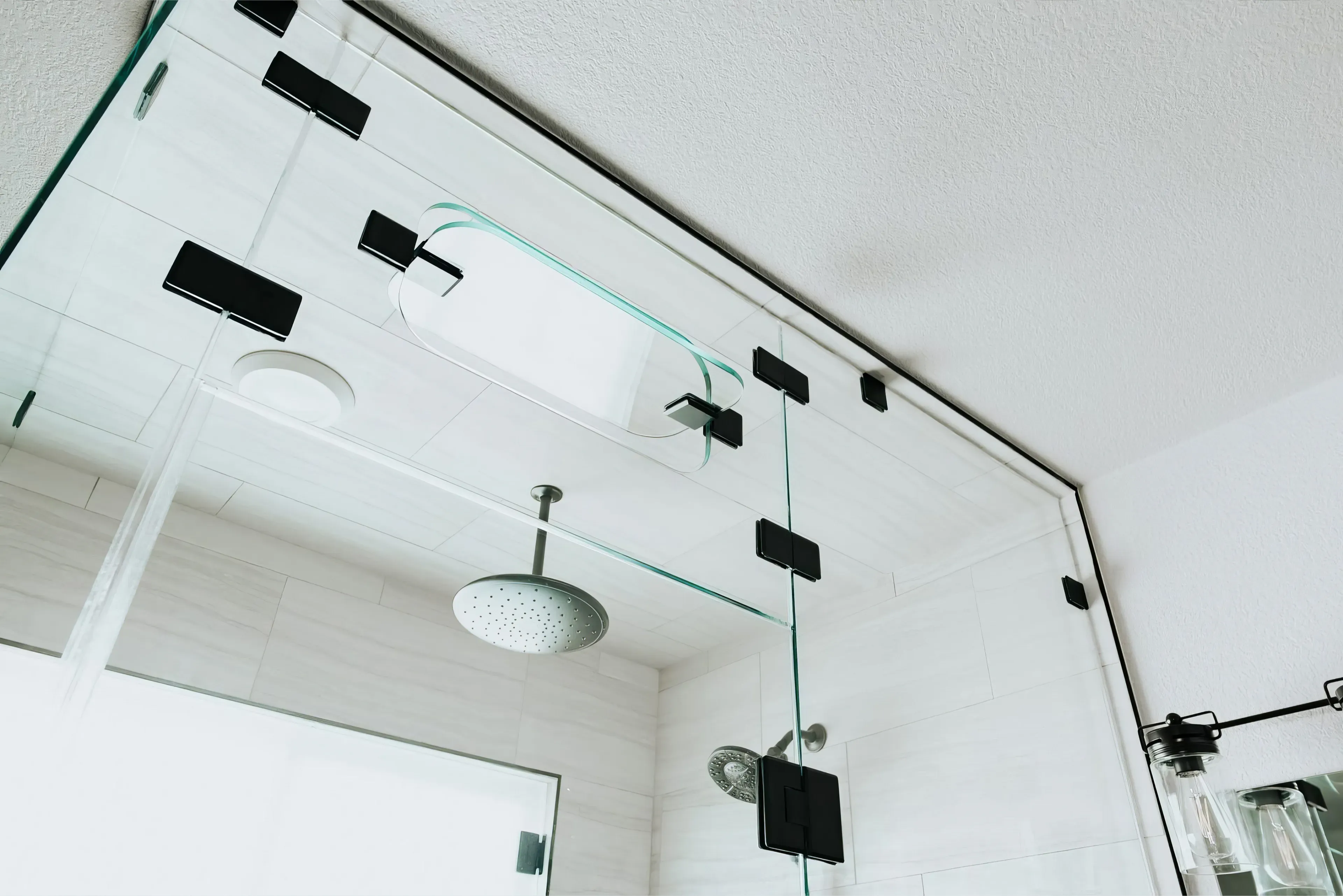 A photograph of a new remodeled bathroom with a walk-in shower, small sauna