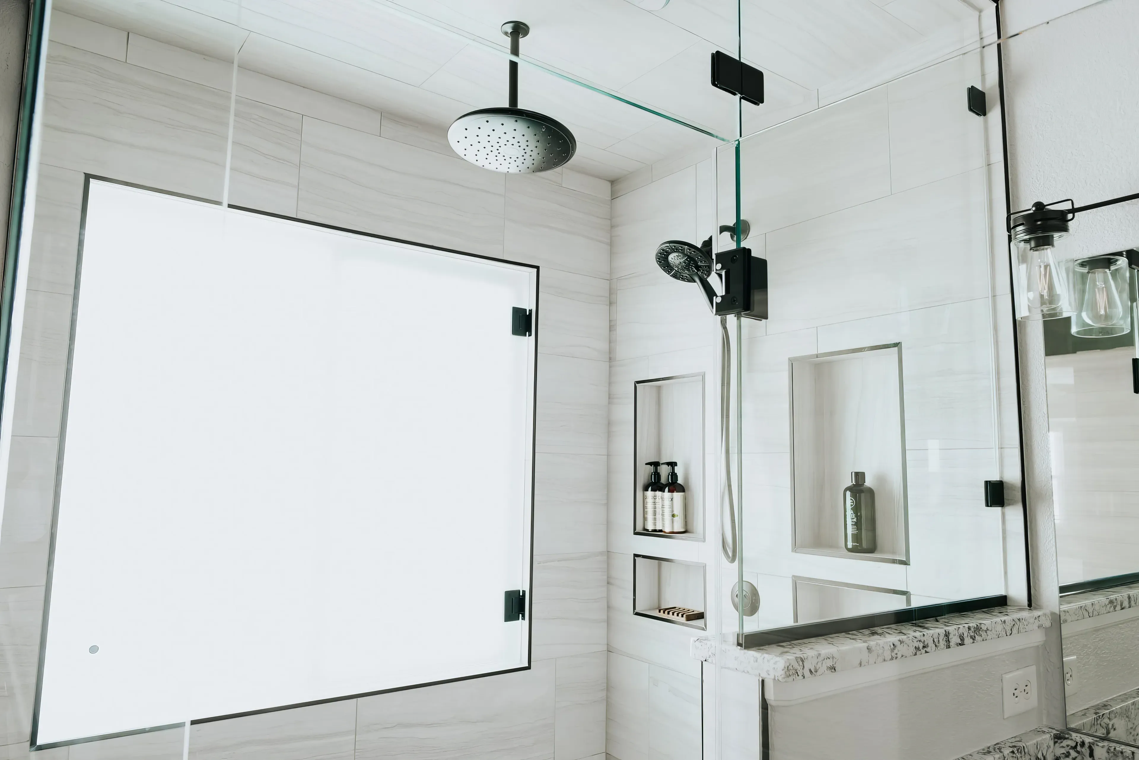 A photograph of a new remodeled bathroom with a walk-in shower & small sauna