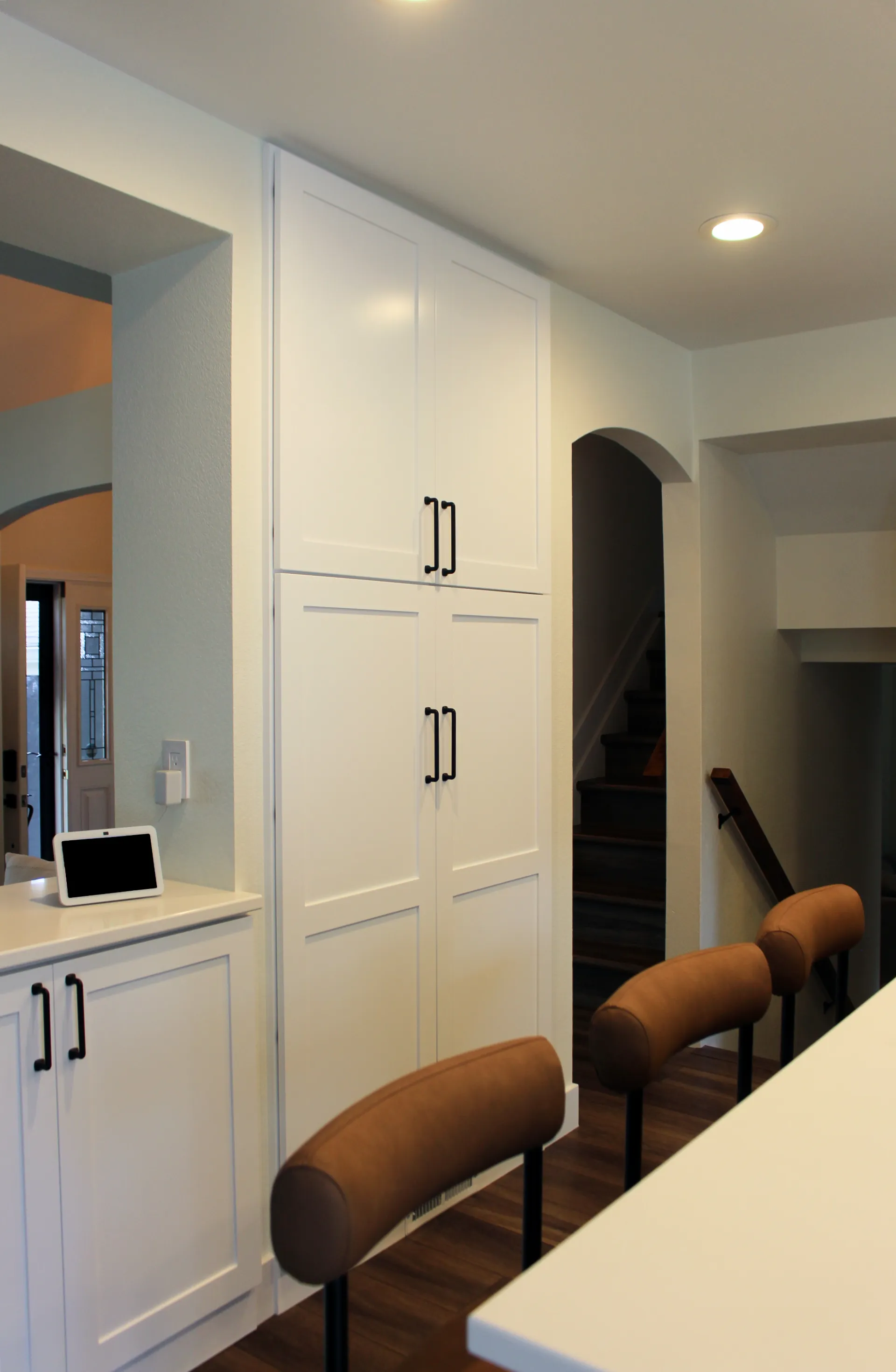 A photograph of custom white kitchen cabinets.