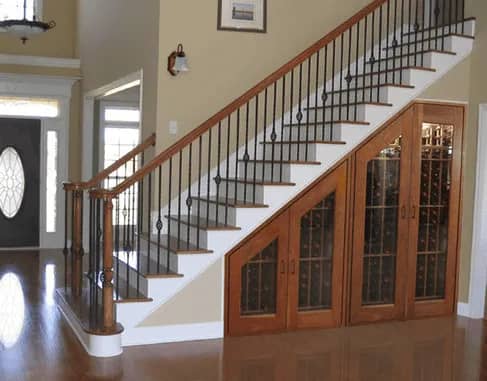 Nice wooden doors leading to underneath a staircase that is used for storage