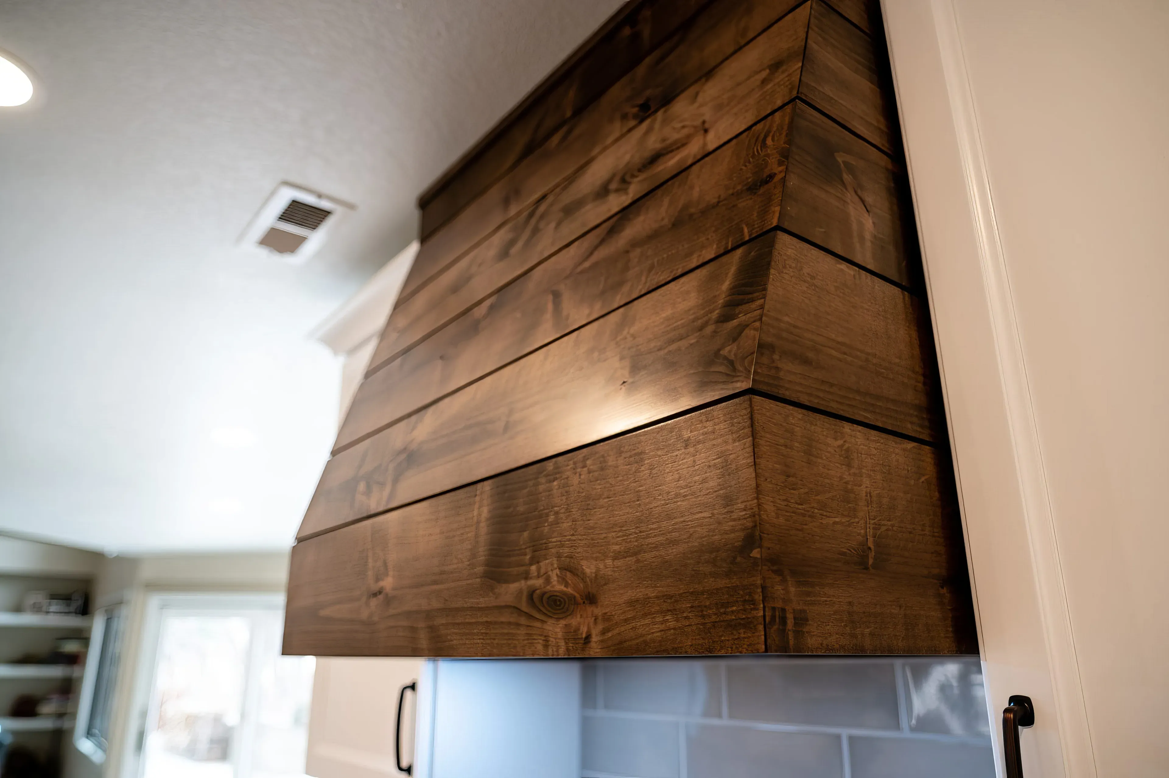 A custom wooden oven hood crafted by Homefix in Colorado Springs