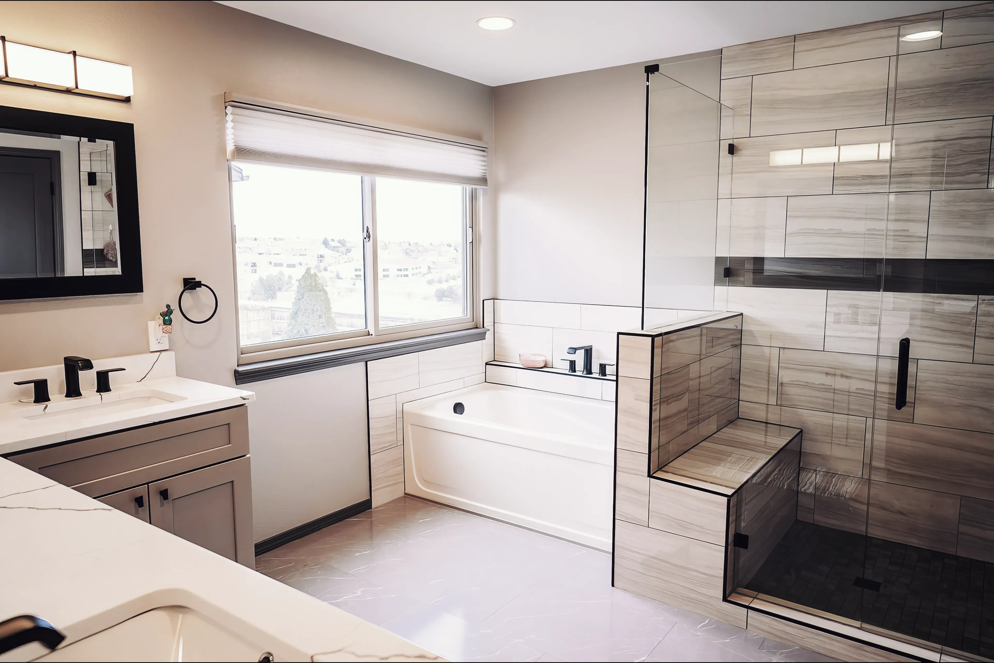 A bathroom walk-in shower remodel in Colorado Springs with modern frameless glass and a deep luxury bath tub