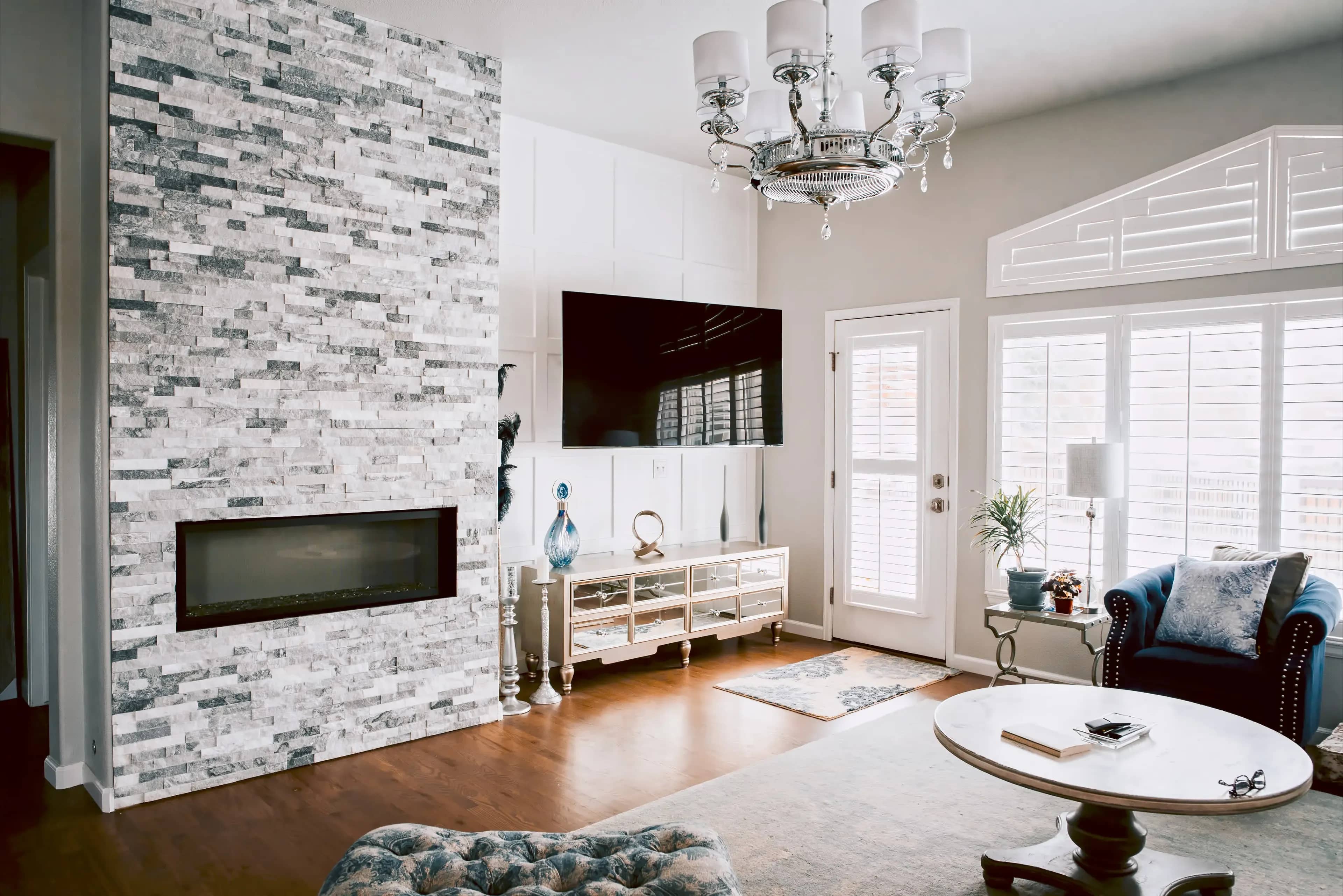 A photograph of a living room freshly remodeled with a new electric fire place installed