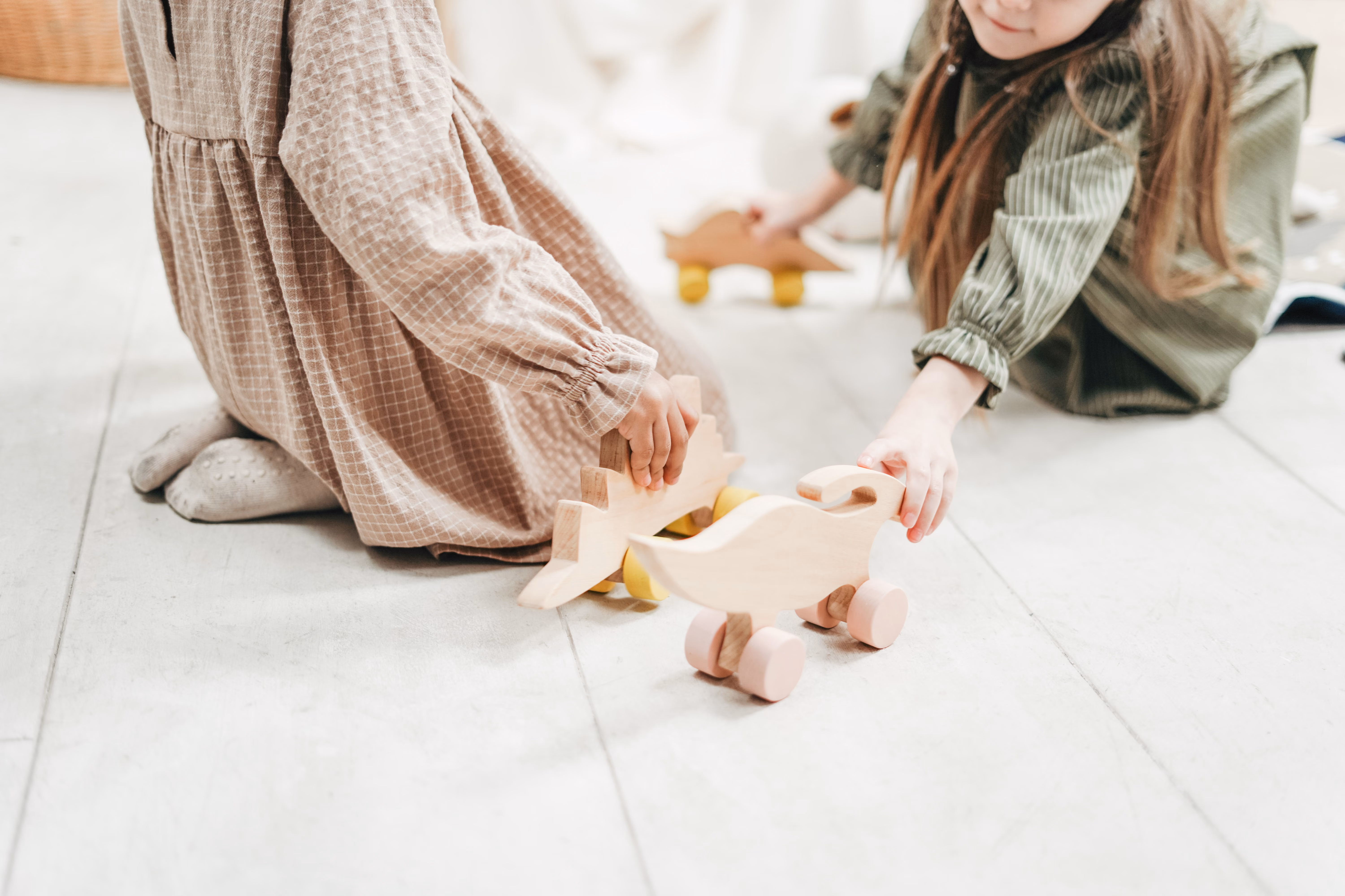 Two children sitting on the floor playing