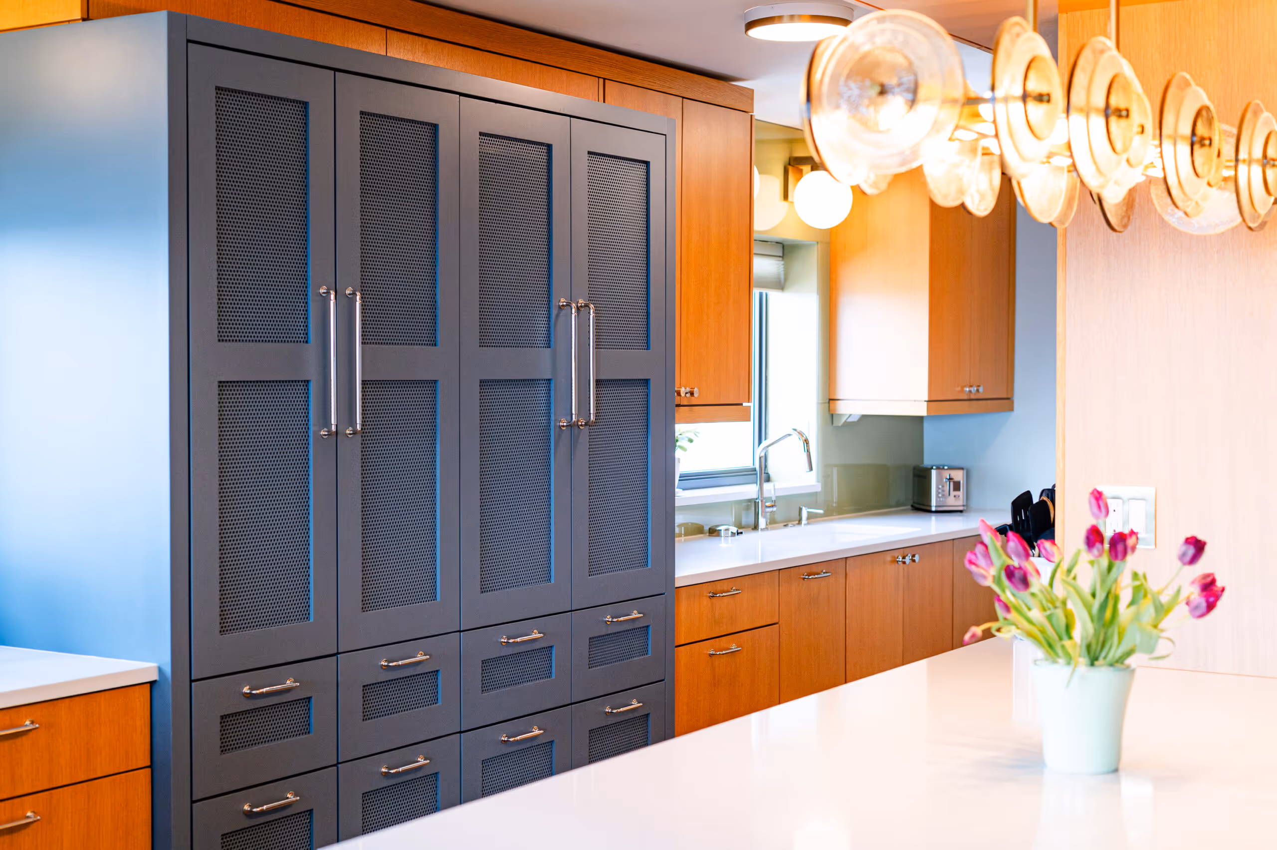 Close-up of perforated metal panel disguising HVAC system near bar cabinet 