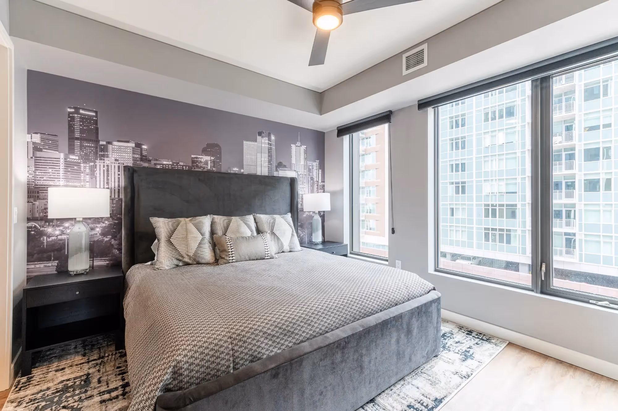 Primary bedroom with Denver skyline mural, upholstered headboard