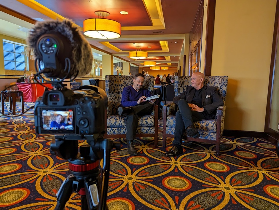 Camera films an interview between an edtech CEO and an education author at the California League of Schools conference.