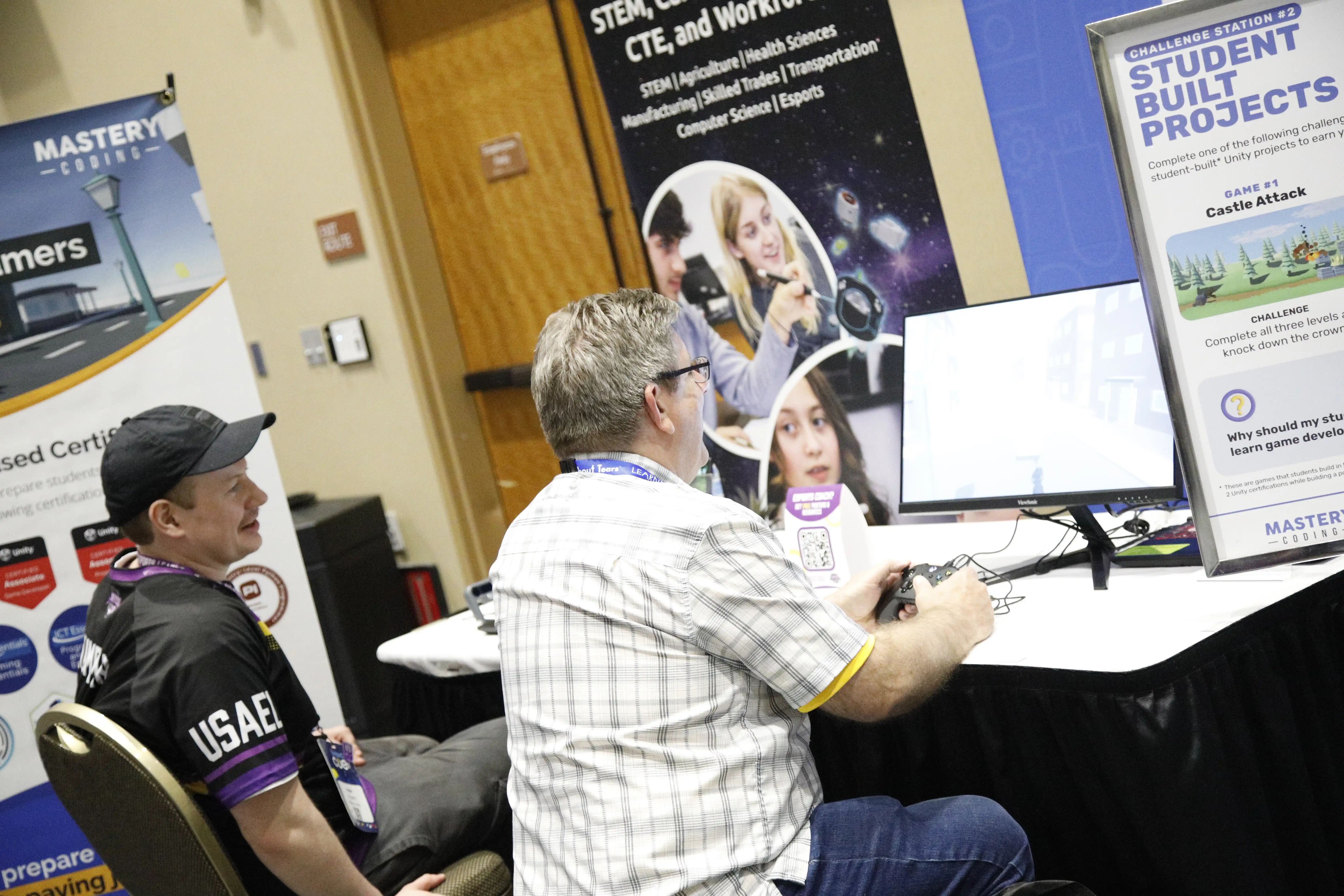 EdTech conference attendee testing student-built game projects at a CTE and esports education booth