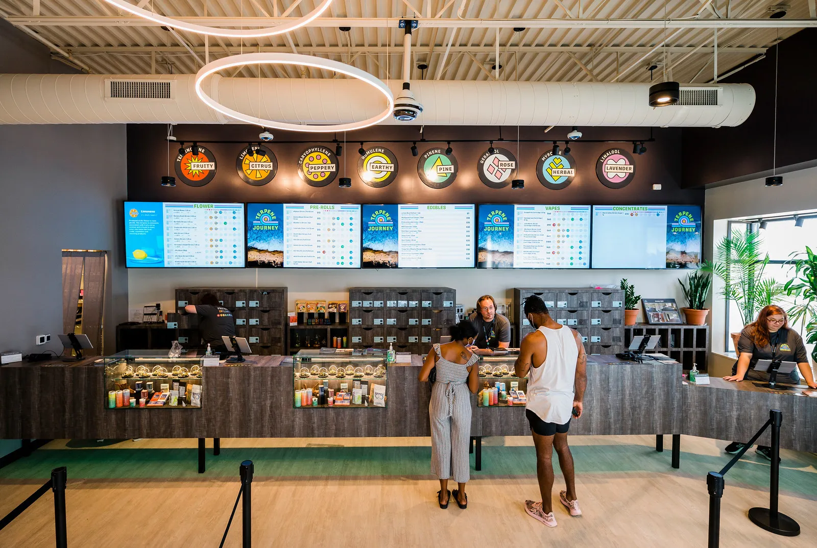 terpene journey swampscot dispensary store counter with two customers looking at weed with staff member assisting