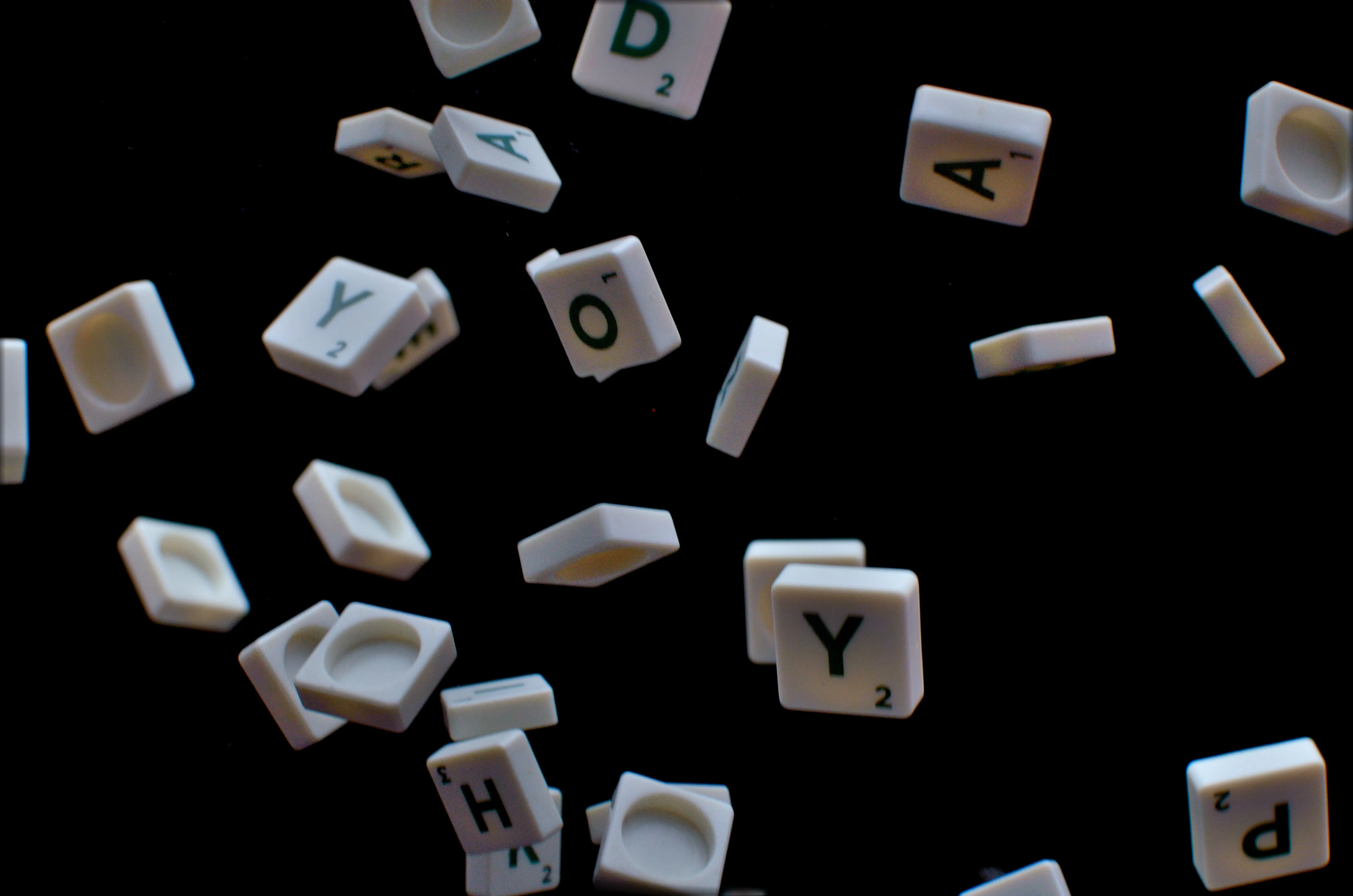 scrabble letters falling with dark background