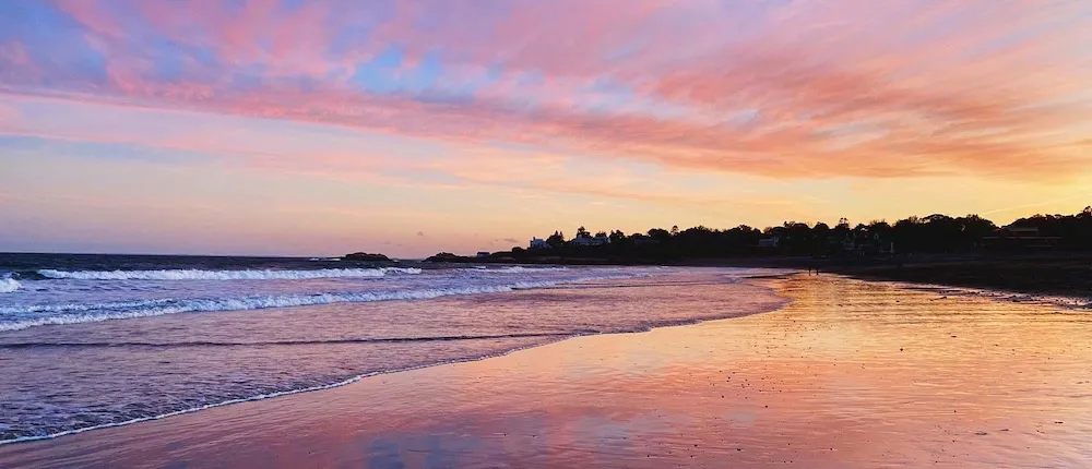 An image of a beach with sunset