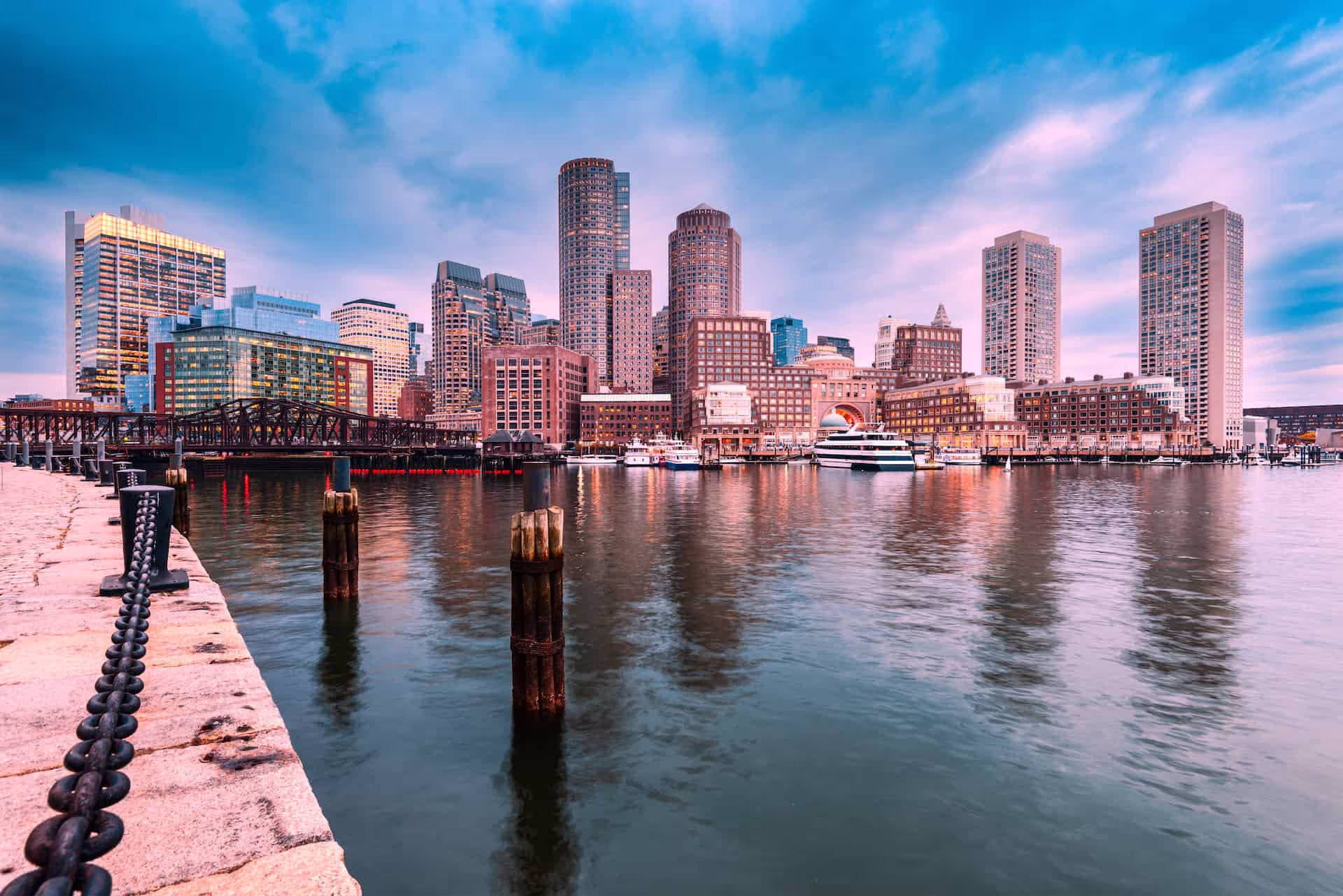 boston skyline at dusk with skyscrapers and seafront