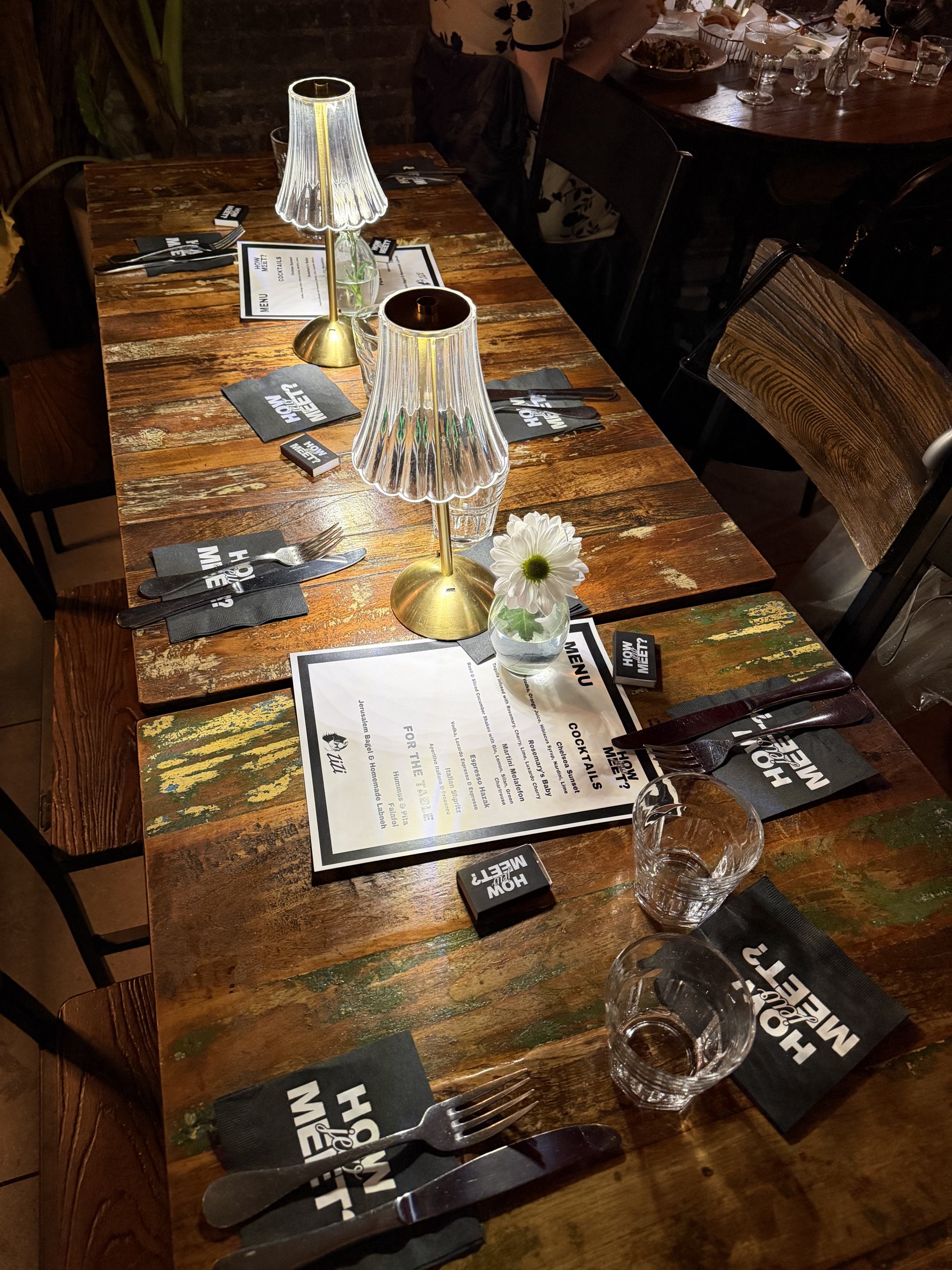 A How Jew Meet dinner table set with name cards and menus