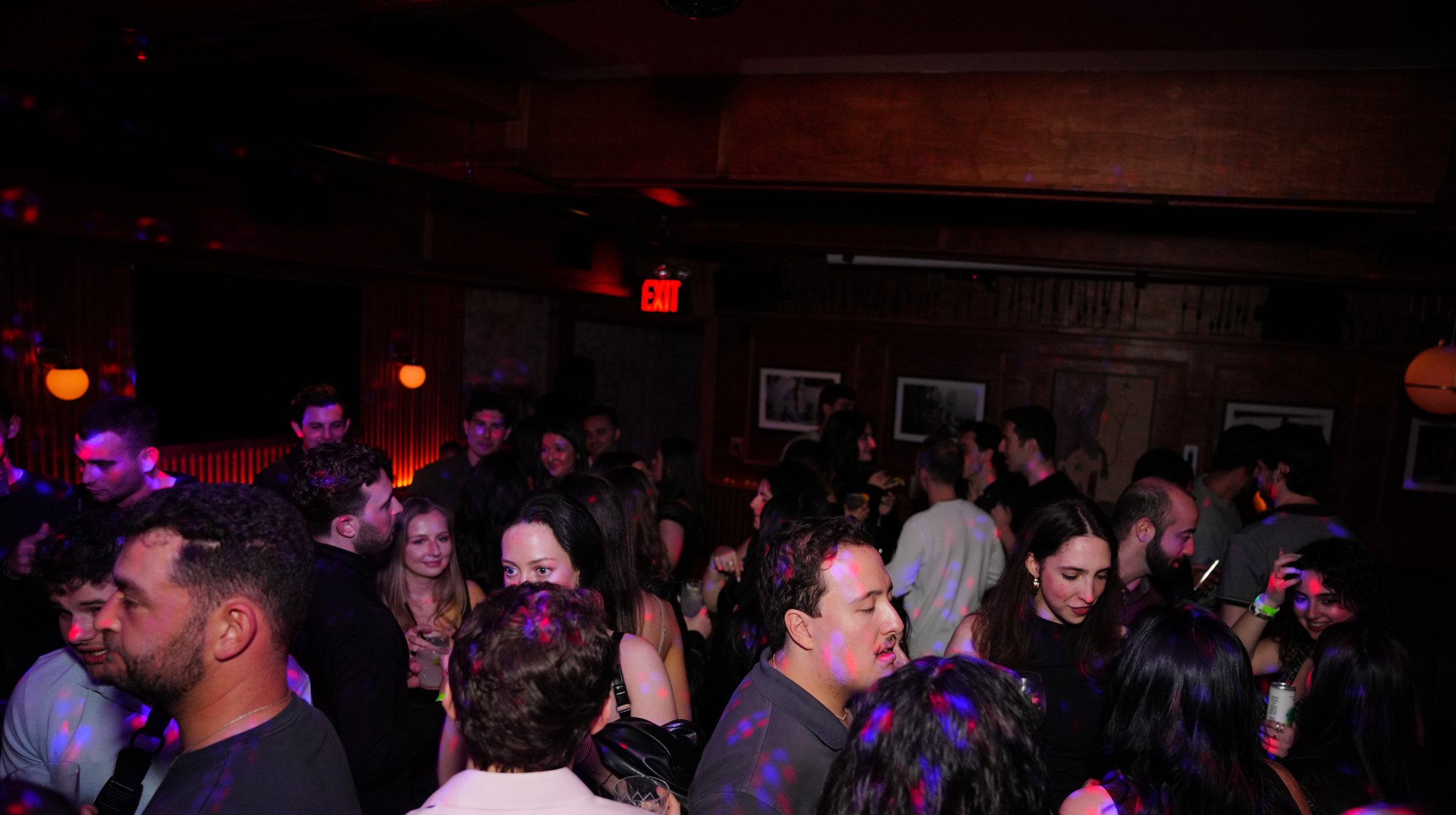 Guests on a crowded dance floor under party lights