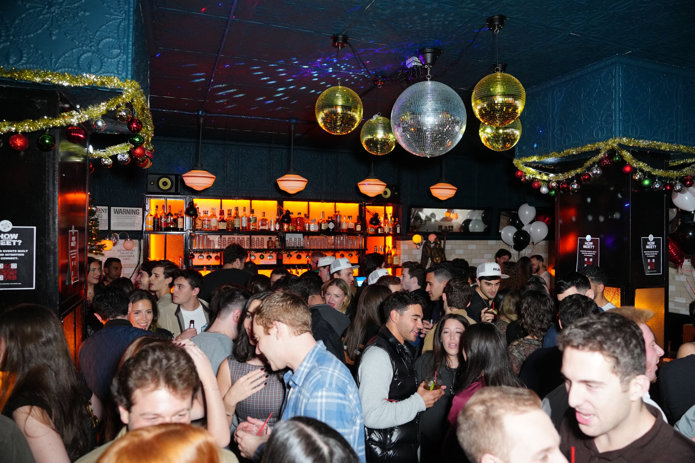 A packed How Jew Meet party under disco balls