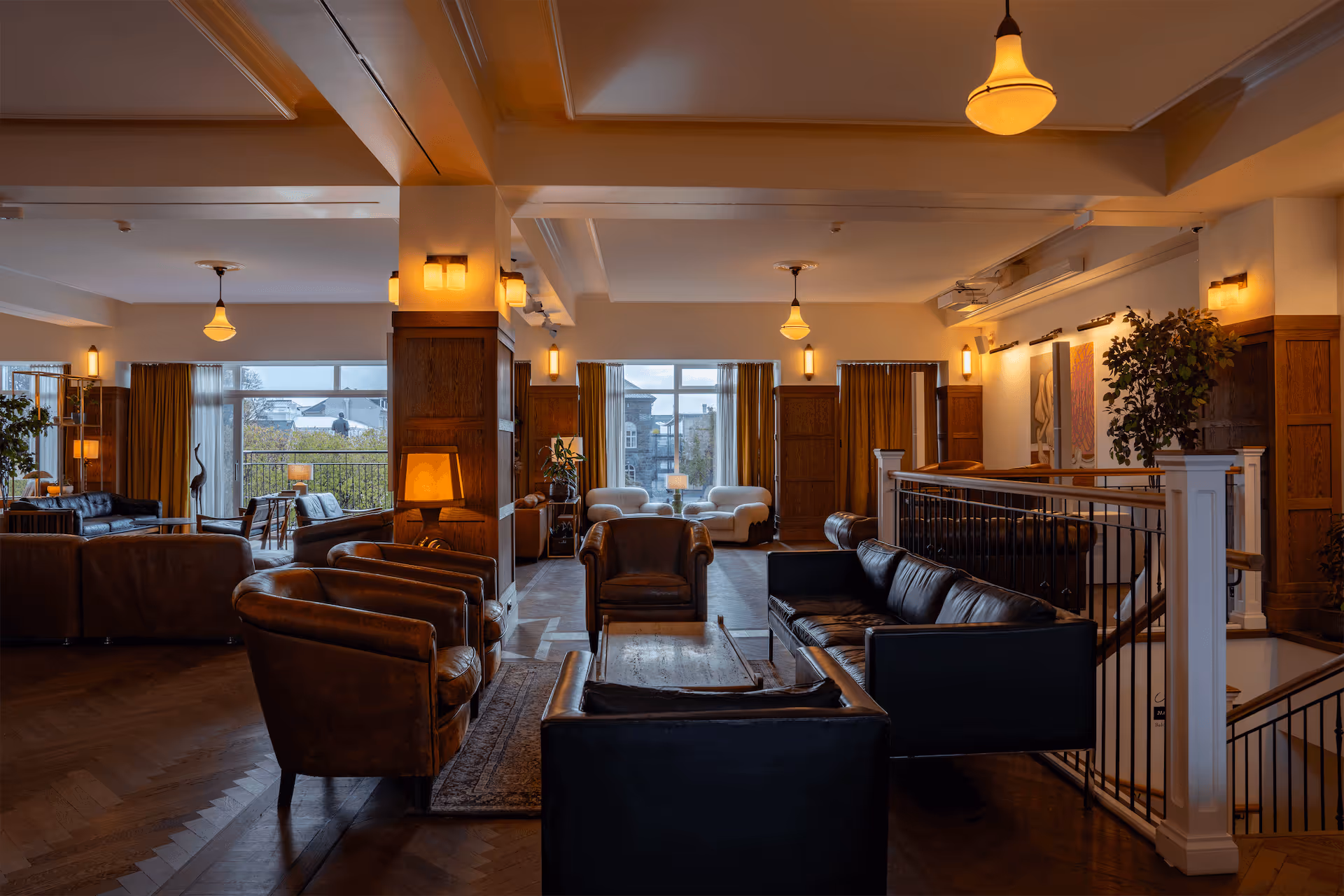 Grand lounge area at Fantasia event venue with premium leather seating, wooden paneling, and scenic city views