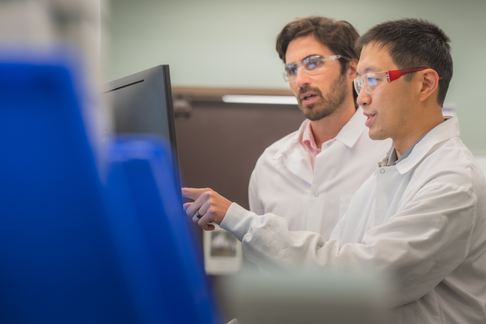 Scientists discussing chemistry in an automated laboratory