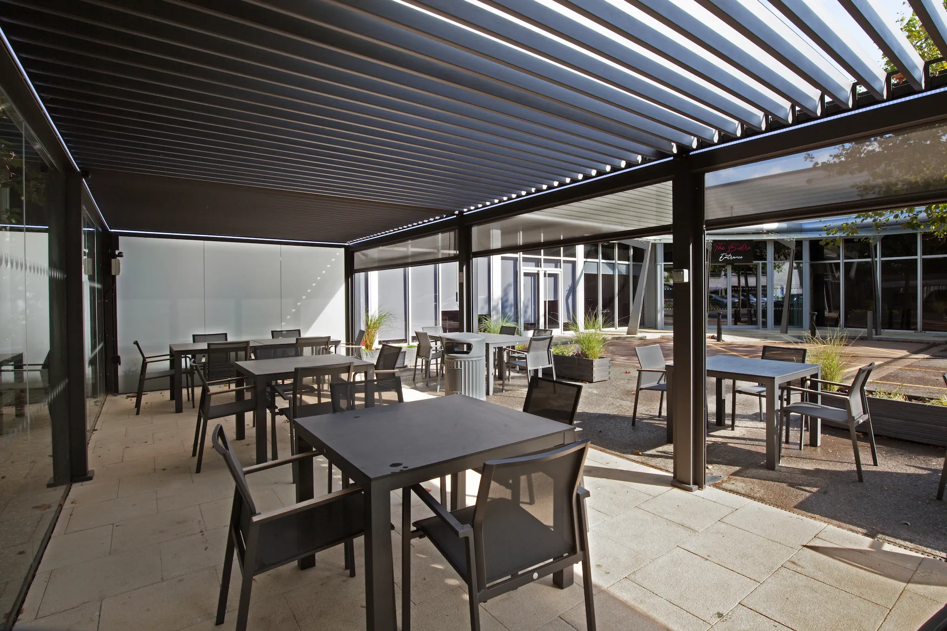 Interior view of the bistro cafes outdoor seating area filled with tables and chairs ideal for summer lunches