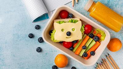 Pediatrician and family discussing a produce prescription box for a child.