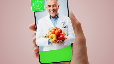 Oncology patient in infusion suite with dietitian and medically tailored meal tray.