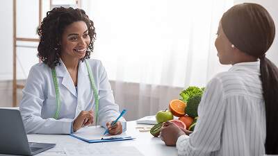 Healthy meals arranged with medical tools to illustrate improved treatment adherence through clinically guided nutrition.