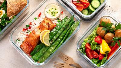 Healthcare professional showing a patient a meal plan on a tablet — illustrating nutrition interventions for chronic disease care